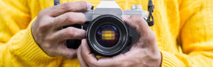 man holding analog camera